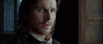 Movie still from “The New World” (2005), directed by Terrence Malick – A person with a beard looking at the camera; Close Up shot, Low angle