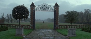 Movie still from “The New World” (2005), directed by Terrence Malick – An open gate leading to a field with a horse in the distance; Extreme Wide shot, Low angle