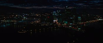 Movie still from “The Next Three Days” (2010), directed by Paul Haggis – A view of a city lit up at night time; Extreme Wide shot, High angle