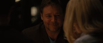 Movie still from “The Next Three Days” (2010), directed by Paul Haggis – A person wearing a suit and tie; Close Up shot, Over the shoulder angle