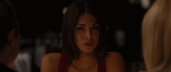 Movie still from “The Next Three Days” (2010), directed by Paul Haggis – A beautiful woman with dark brown hair wearing a red top; Close Up shot, Over the shoulder angle