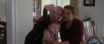 Movie still from “The Next Three Days” (2010), directed by Paul Haggis – A man and a woman and a child taking a selfie; Medium shot, Low angle