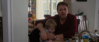 Movie still from “The Next Three Days” (2010), directed by Paul Haggis – A man and a boy are sitting at a table; Medium shot, Over the shoulder angle