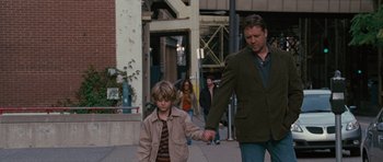 Movie still from “The Next Three Days” (2010), directed by Paul Haggis – A man and a boy walking down a street; Medium shot, Over the shoulder angle