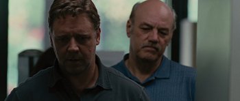 Movie still from “The Next Three Days” (2010), directed by Paul Haggis – Two men standing next to each other in front of a window; Close Up shot, Over the shoulder angle