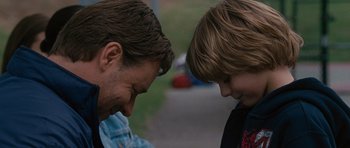 Movie still from “The Next Three Days” (2010), directed by Paul Haggis – A man and a boy face to face in a park; Close Up shot, Over the shoulder angle