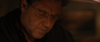 Movie still from “The Next Three Days” (2010), directed by Paul Haggis – A person wearing glasses; Close Up shot, Over the shoulder angle