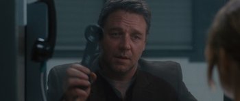 Movie still from “The Next Three Days” (2010), directed by Paul Haggis – A person holding a remote control; Close Up shot, Low angle