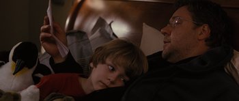 Movie still from “The Next Three Days” (2010), directed by Paul Haggis – A man and a boy sleeping on a bed; Close Up shot, Over the shoulder angle