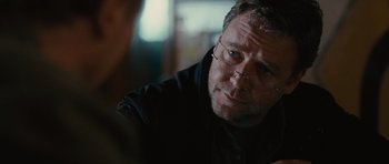 Movie still from “The Next Three Days” (2010), directed by Paul Haggis – A person wearing glasses and a black shirt; Close Up shot, Over the shoulder angle