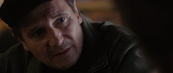 Movie still from “The Next Three Days” (2010), directed by Paul Haggis – A man's face in a dark room; Close Up shot, Over the shoulder angle