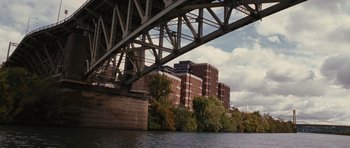 Movie still from “The Next Three Days” (2010), directed by Paul Haggis – A view from under a bridge of a building; Extreme Wide shot, High angle