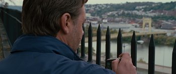Movie still from “The Next Three Days” (2010), directed by Paul Haggis – A man taking a picture with his cell phone; Close Up shot, High angle