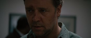 Movie still from “The Next Three Days” (2010), directed by Paul Haggis – A man's face in a darkened room; Close Up shot, Over the shoulder angle
