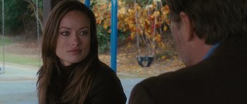 Movie still from “The Next Three Days” (2010), directed by Paul Haggis – A woman sitting in front of a man on a swing set; Close Up shot, Over the shoulder angle