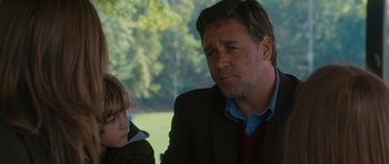 Movie still from “The Next Three Days” (2010), directed by Paul Haggis – A man and a boy are sitting in front of a tree; Close Up shot, Over the shoulder angle