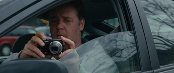 Movie still from “The Next Three Days” (2010), directed by Paul Haggis – A man taking a picture of himself in a car mirror; Close Up shot, Over the shoulder angle
