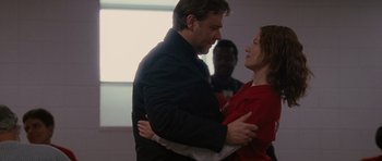 Movie still from “The Next Three Days” (2010), directed by Paul Haggis – A man and a woman are hugging in a room; Medium shot, Low angle