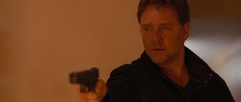 Movie still from “The Next Three Days” (2010), directed by Paul Haggis – A person holding a gun; Close Up shot, Over the shoulder angle