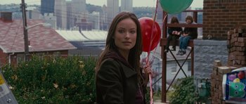 Movie still from “The Next Three Days” (2010), directed by Paul Haggis – A woman holding a bunch of red balloons; Medium shot, Over the shoulder angle