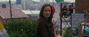 Movie still from “The Next Three Days” (2010), directed by Paul Haggis – A beautiful young lady standing next to a bunch of balloons; Medium shot, Over the shoulder angle