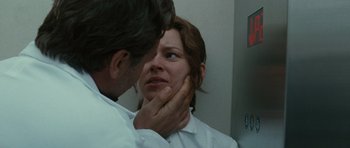 Movie still from “The Next Three Days” (2010), directed by Paul Haggis – A doctor examining a woman's face in the mirror; Close Up shot, Low angle