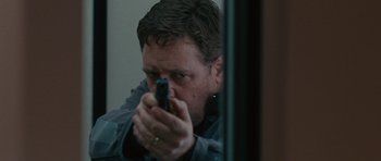 Movie still from “The Next Three Days” (2010), directed by Paul Haggis – A man holding a gun in front of a mirror; Close Up shot, Over the shoulder angle