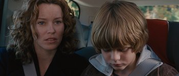 Movie still from “The Next Three Days” (2010), directed by Paul Haggis – A woman and a boy sitting in the back of a car; Close Up shot, Over the shoulder angle