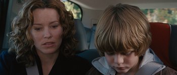 Movie still from “The Next Three Days” (2010), directed by Paul Haggis – A woman sitting next to a child in a car; Close Up shot, Over the shoulder angle