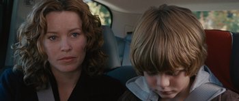 Movie still from “The Next Three Days” (2010), directed by Paul Haggis – A woman sitting next to a child in a car; Close Up shot, Over the shoulder angle