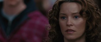 Movie still from “The Next Three Days” (2010), directed by Paul Haggis – A person with curly hair; Close Up shot, Over the shoulder angle