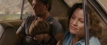 Movie still from “The Next Three Days” (2010), directed by Paul Haggis – A man and a woman sitting next to a boy; Close Up shot, Over the shoulder angle