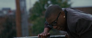Movie still from “The Next Three Days” (2010), directed by Paul Haggis – A man leaning on a railing looking down at the ground; Close Up shot, Low angle