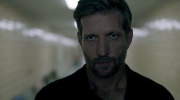 Movie still from “The Night Of” (2016), directed by James Marsh – A person wearing a black shirt; Close Up shot, Over the shoulder angle