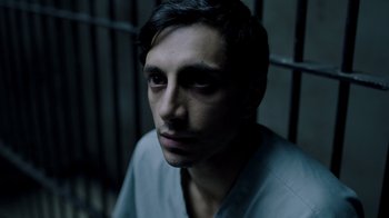 Movie still from “The Night Of” (2016), directed by James Marsh – A man in a jail cell with his eyes wide open; Close Up shot, High angle