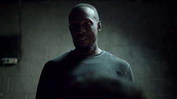 Movie still from “The Night Of” (2016), directed by James Marsh – A man with a beard is standing in a dark room; Close Up shot, Low angle