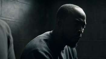 Movie still from “The Night Of” (2016), directed by James Marsh – A person wearing a black shirt; Close Up shot, Over the shoulder angle