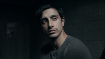 Movie still from “The Night Of” (2016), directed by James Marsh – A person wearing a gray shirt; Close Up shot, Low angle