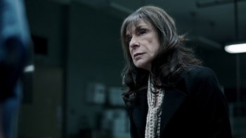 Movie still from “The Night Of” (2016), directed by James Marsh – A woman with long hair wearing a black jacket; Close Up shot, Low angle