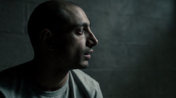 Movie still from “The Night Of” (2016), directed by James Marsh – A man with a bald head looking to the side; Close Up shot, High angle