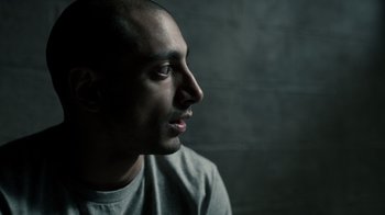 Movie still from “The Night Of” (2016), directed by James Marsh – A person looking to his left; Close Up shot, Over the shoulder angle