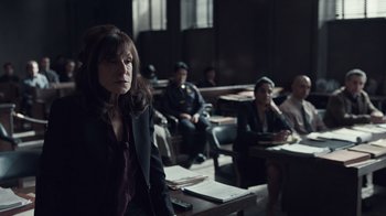 Movie still from “The Night Of” (2016), directed by James Marsh – A group of people sitting in a room with papers; Medium shot, Over the shoulder angle