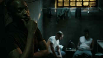 Movie still from “The Night Of” (2016), directed by James Marsh – A group of people sitting in a room; Close Up shot, Over the shoulder angle
