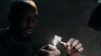 Movie still from “The Night Of” (2016), directed by James Marsh – A man lighting a cigarette in the dark; Close Up shot, Low angle