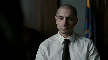 Movie still from “The Night Of” (2016), directed by James Marsh – A man in a white shirt and a black tie; Close Up shot, Over the shoulder angle