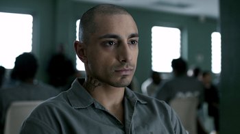 Movie still from “The Night Of” (2016), directed by James Marsh – A person wearing a gray shirt; Close Up shot, Low angle