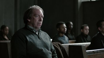 Movie still from “The Night Of” (2016), directed by James Marsh – A group of people sitting in a room; Medium shot, Over the shoulder angle