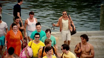 Movie still from “The Normal Heart” (2014), directed by Ryan Murphy – A group of men standing next to a body of water; Wide shot, High angle