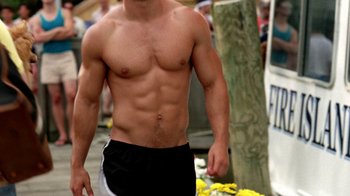 Movie still from “The Normal Heart” (2014), directed by Ryan Murphy – A man walking down the street with no shirt on; Medium shot, High angle