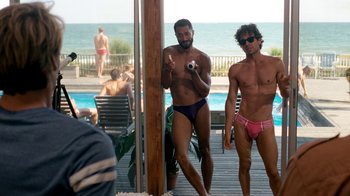 Movie still from “The Normal Heart” (2014), directed by Ryan Murphy – A couple of men standing next to each other on top of a deck; Wide shot, Over the shoulder angle